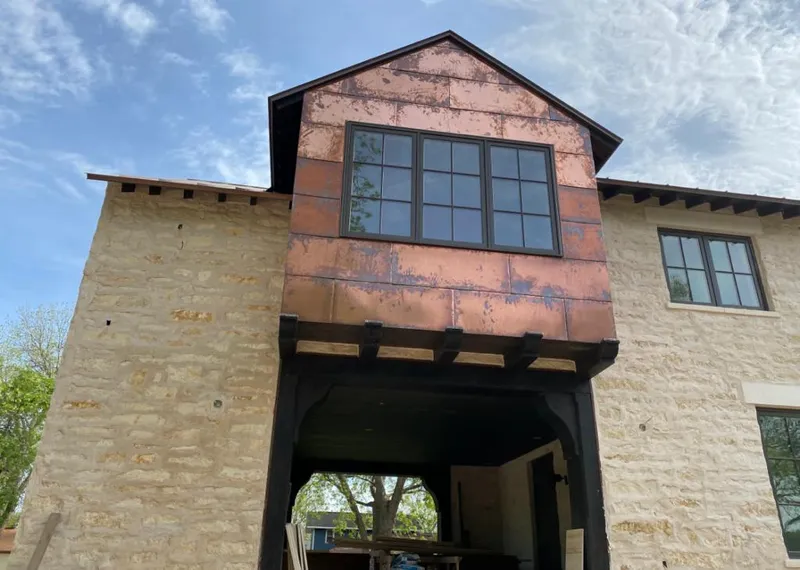Copper metal panel facade on a stone building for Roof Repair in Oak Lawn