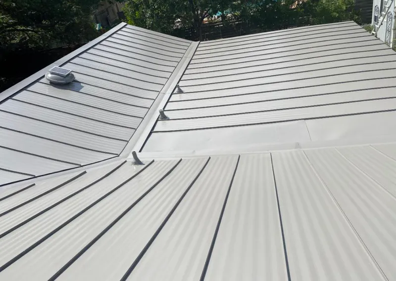 Solar attic fan installed on a metal roof for Roof Ventilation in Oak Lawn